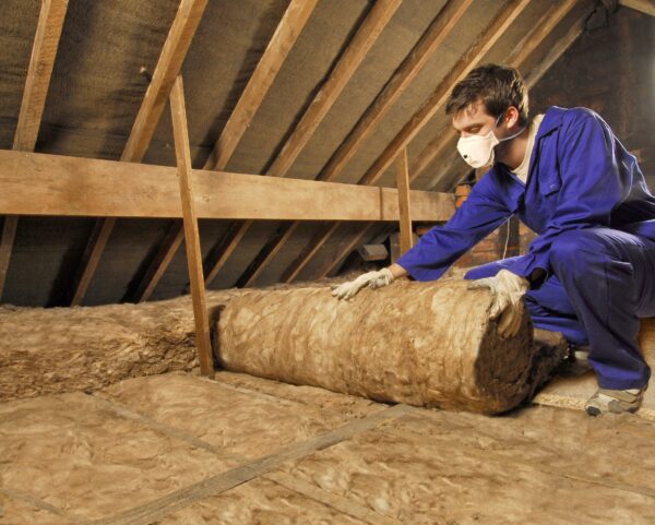 man-installing-loft-insulation-roll